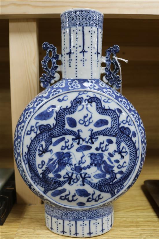 A Chinese blue and white moon flask decorated with dragons